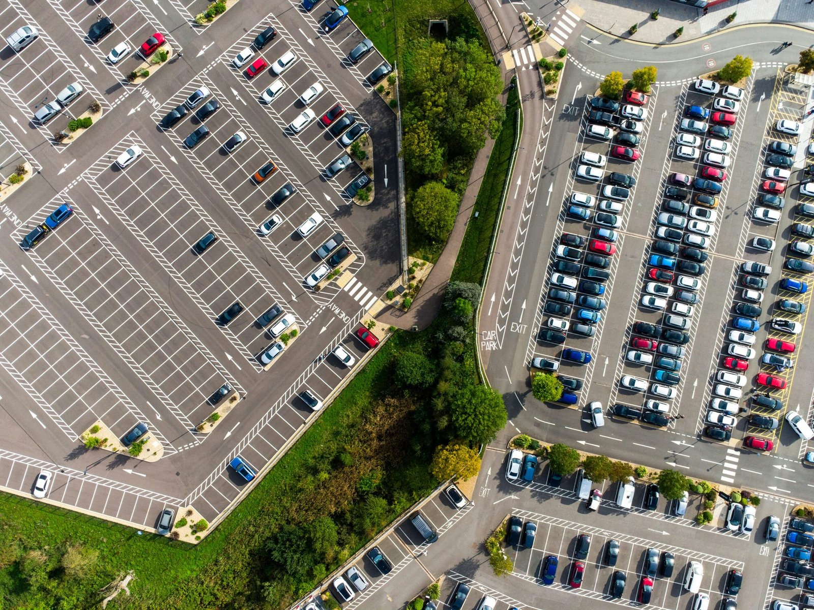 an aerial view of a parking lot with cars parked in it